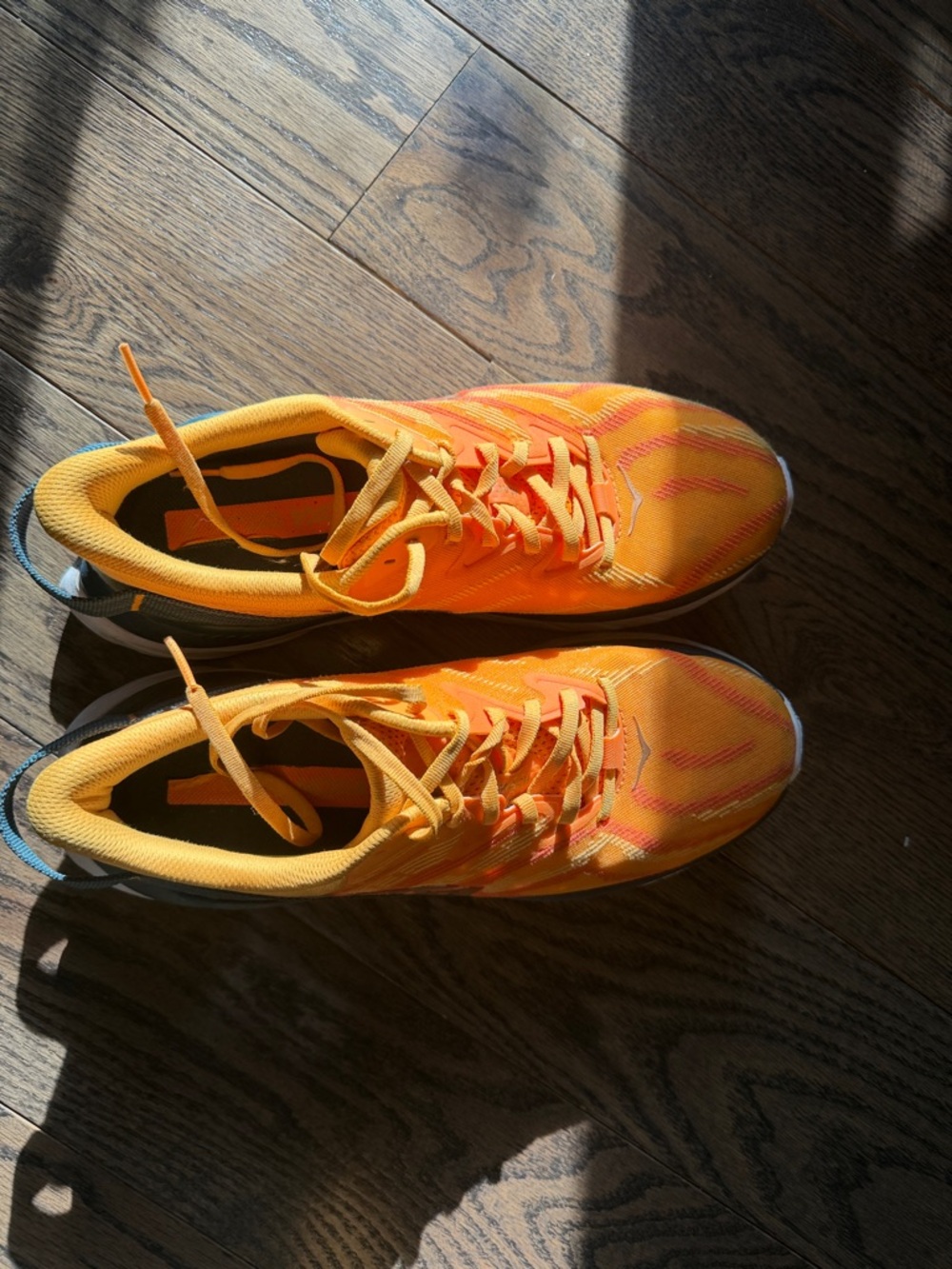 HOKA women’s/men’s s unisex Orange Athletic running Sneakers with Blue Accent